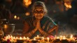 Old indian woman pray with candles. Night shot