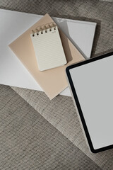 Wall Mural - tablet pad with blank copy space screen, blank notebook on sofa. flat lay, top view