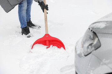 Wall Mural - Man removing snow with shovel near car outdoors, closeup