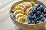 Fototapeta Mapy - AI-generated illustration of a bowl of porridge with sliced banana and blueberries