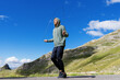 © makedonski2015 - Training outside. An athlete jumps on a rope against the background of mountains. Sunny weather and blue sky.