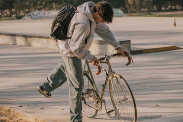 Poster - young man on the street riding on vintage bicycle