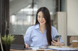 © SOMKID - Happy asian young businesswoman excited with smartphone at workplace, Excited happy Asian woman.