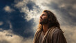 Jesus Christ looking up toward the sky. A portrait of the Savior during his ministry years. dramatic skies.