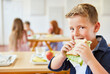 © Robert Kneschke - Boy eating fresh sandwich at school cafeteria