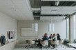 © Maskot - Multiracial business colleagues discussing strategy through video conference in board room
