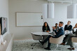 © Maskot - Business colleagues discussing strategy through video conference in board room