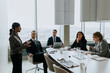 © Maskot - Mature businesswoman explaining strategy to colleagues in board room during meeting
