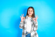 © Roquillo - Beautiful kid girl wearing plaid shirt showing both hands with fingers in OK sign. Approval or recommending concept