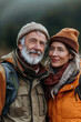 © Creative Clicks - Senior couple in warm clothing enjoying a hiking adventure outdoors.