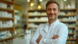 © akarawit - Portrait of a male pharmacist standing in modern pharmacy
