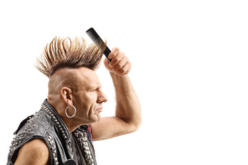 Canvas Print - Punk fixing his mohawk hairstyle with a comb