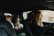 © Maskot - Mother driving while son and daughter sitting behind in car during weekend trip