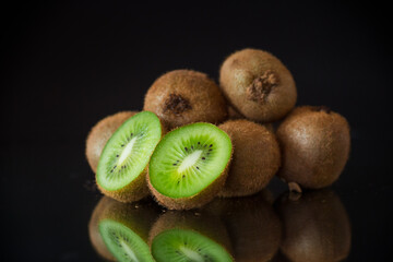 Wall Mural - Kiwi fruit slice closeup on black background