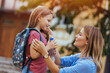 © Dragana Gordic - First day at school. mother leads a little child school girl in first grade. Mother Saying Goodbye To Children As They Leave For School