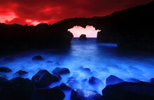 Volcanic Arches At Sunrise In El Hierro With A Luminous Blue Sea Under A Dramatic Red Sky