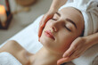 © AI_images - Close up masseur hands making face relaxing massage to a young girl lying with closed eyes in beauty salon or cosmetology cabinet. Professional cosmetologist making massage for woman in spa