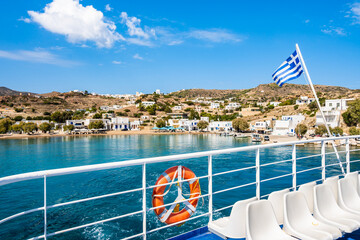 Wall Mural - Deck of ferry with Greek flag leaving Milos island and sailing to Kimolos island, Cyclades, Greece