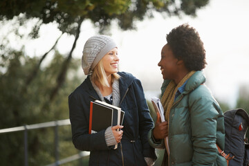 Canvas Print - Women, university student and friends with book on campus for sharing, information and notes on research. Classmates, campus and knowledge with advice to prepare for assignment submissions.