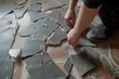 person fitting pieces of cracked floor together