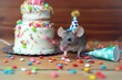 mouse with party hat, miniature cake on table