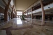 wideangle view of a spacious, unoccupied hotel lobby with marble floors