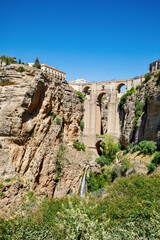 Wall Mural - Ronda, Spain. Aerial evening view of New Bridge over Guadalevin River in Ronda, Andalusia, Spain. View of the touristic city.