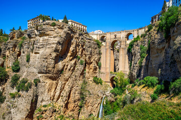 Wall Mural - Ronda, Spain. Aerial evening view of New Bridge over Guadalevin River in Ronda, Andalusia, Spain. View of the touristic city.