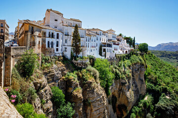 Wall Mural - Ronda, Spain. Aerial evening view of New Bridge over Guadalevin River in Ronda, Andalusia, Spain. View of the touristic city.