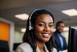 © Ievgen Tytarenko - Portrait of a smiling African-American businesswoman working in a creative office. A young woman looks into the camera during a video call with headphones.
