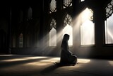 Fototapeta Przestrzenne - Muslim woman praying in the mosque with rays of light coming through the window. spirituality. prayer place. islamic faith. religious acts.