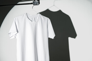 Wall Mural - Blank T-shirt hanging in a spotlight in studio