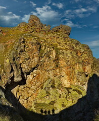 Russia, the Elbrus region. Contrasting shadow on the rock in the form of four tourists conquering the highest mountain of the Caucasus - Elbrus (5642 m).