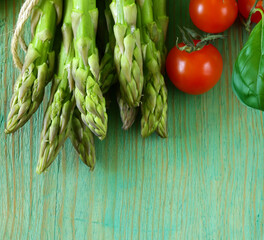 Poster - organic fresh green asparagus on wooden table