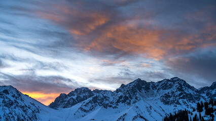  a beautiful pink dawn in the snowy mountains. early morning in the winter mountains