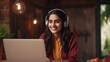 © chanidapa - Cheerful indian woman wear headset laugh using laptop video stream conference call teach online, happy ethnic girl student gamer tutor have fun watch webinar web cam education entertainment concept