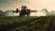 spraying crops with a tractor in farm field