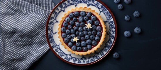 Poster - Top view on blueberry mini tart served on blue ceramic plate over gray textile napkin Top view Square image. Creative Banner. Copyspace image