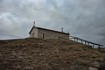 Sticker - Chapel in a hill against cloudy sky