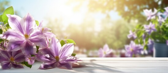 Poster - Natural summertime cooking template fresh green leaves and violet flowers of clematis over an empty empty table with violet checkered tablecloth on a sunny day with copy space. Creative Banner