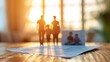 Paper cutout of a family standing on a legal document on a wooden table with a photo and warm backlight.
