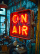 Classic 'ON AIR' illuminated sign in bold red letters indicating live broadcast or recording in progress in a radio, television studio or podcast