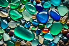 Blue And Green Stones, Colorful Gemstones On A Beach. Polish Textured Sea Glass And Stones On The Seashore. Green, Blue Shiny Glass With Multi-colored Sea Pebbles Close-up