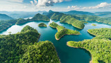 Fototapeta  - Sustainable habitat world concept. Distant aerial view of a dense rainforest vegetation with lakes in a shape of world continents, clouds and one small yellow