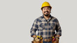 © MP Studio - A cheerful worker in a plaid shirt and yellow hard hat, equipped with a tool belt holding various tools, confidently standing with a hand on his hip.