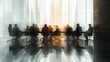 silhouettes of business people are seen in a meeting room