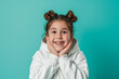 © Alina Zavhorodnii - A little girl makes different faces of surprise or fright, smiling on a colored background