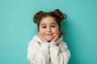 © Alina Zavhorodnii - A little girl makes different faces of surprise or fright, smiling on a colored background