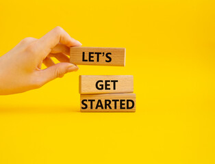 Wall Mural - lets get started symbol. concept words lets get started on wooden blocks. beautiful yellow backgroun
