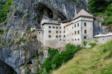 Sticker - Predjama, Slovenia - June 27, 2023: Predjama Castle in Slovenia, Europe. Renaissance castle built within a cave mouth in south central Slovenia.